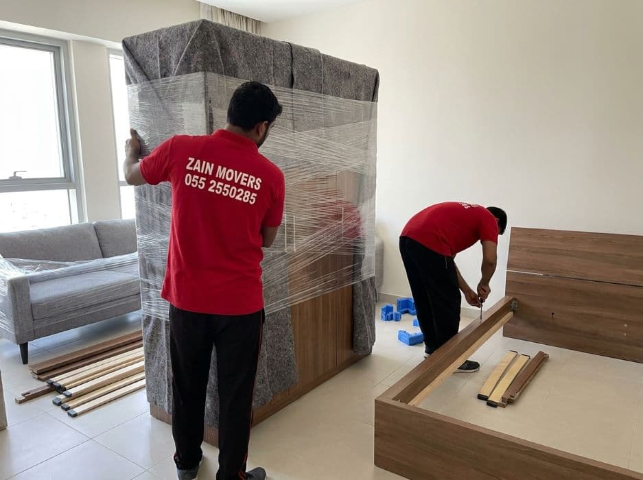Zain Movers carpenter dismantling a wardrobe for transport